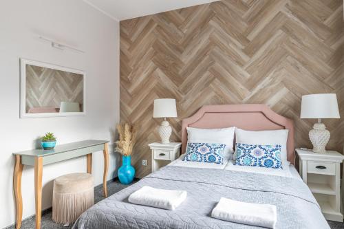 a bedroom with a bed and a wooden wall at Przystań Stegna in Stegna