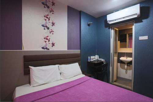 a bedroom with a bed and a sink in it at T-Hotel Bukit Bintang in Kuala Lumpur
