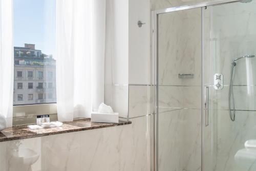 a bathroom with a shower with a glass door at Bianca Maria Palace Hotel in Milan