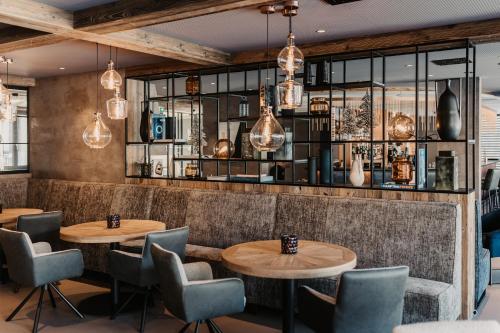 a restaurant with two tables and chairs at THE MATTHEW - Copper Lodge in Wagrain