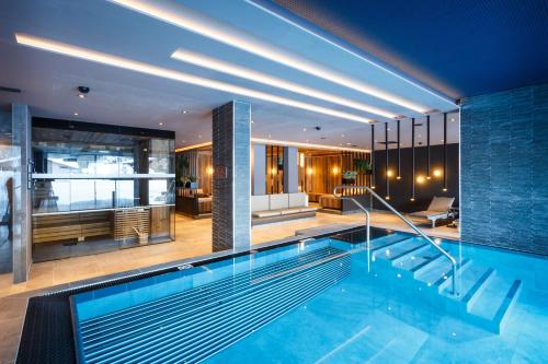 a swimming pool in a house with a living room at THE MATTHEW - Copper Lodge in Wagrain