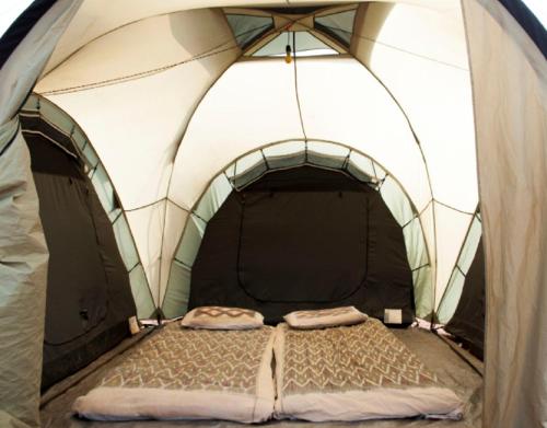 a bed in the inside of a tent at StayApart - Deccan Trails Vikarabad in Vikārābād
