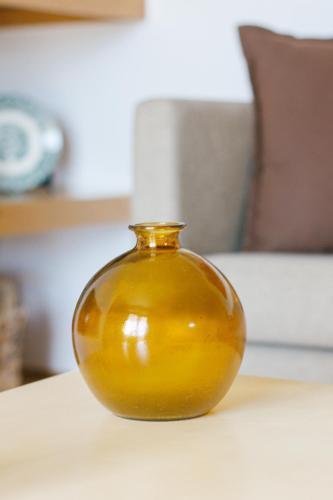 a yellow vase sitting on top of a table at Quinta de Fiães in Vilar de Maçada