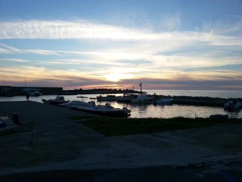 a group of boats docked in a harbor at sunset at Dimora ideale SALENTO3 per coppia vista mare mozzafiato immersa nel verde per gli amanti della tranquilità in Alessano