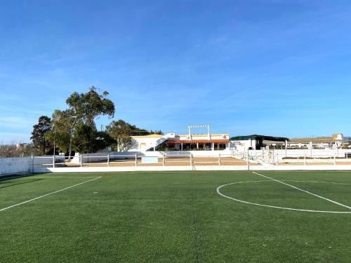 a tennis court in front of a building at Herdade dos Salgados do Fialho in Faro