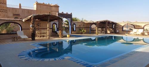 a swimming pool in the middle of a building at Dar Tafouyte in Merzouga