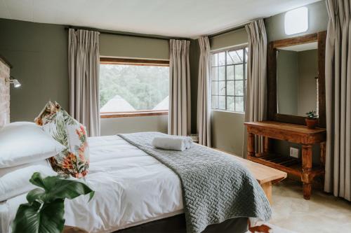 a bedroom with a bed and a mirror and a piano at Breathe River Retreat in Parys