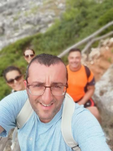 a man wearing glasses is smiling at the camera at Dimora ideale SALENTO3 per coppia vista mare mozzafiato immersa nel verde per gli amanti della tranquilità in Alessano
