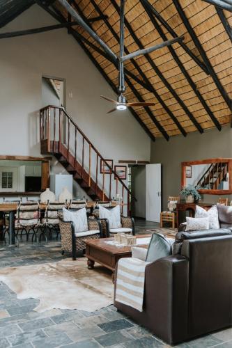a large living room with couches and a table at Breathe River Retreat in Parys