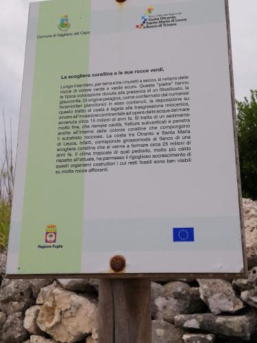 a sign on top of a pile of rocks at Dimora ideale SALENTO3 per coppia vista mare mozzafiato immersa nel verde per gli amanti della tranquilità in Alessano
