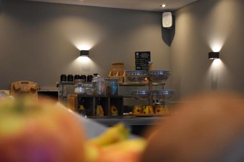 a kitchen with a counter with food on it at Hotel Atlanta in Valkenburg