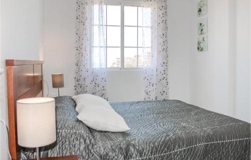 Schlafzimmer mit einem Bett und einem Fenster in der Unterkunft Awesome Apartment In Torrevieja With Kitchenette in Torrevieja