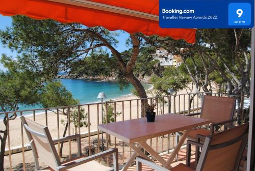 a table and chairs on a balcony with a view of the beach at Apto. Plana - 374 in Llafranc