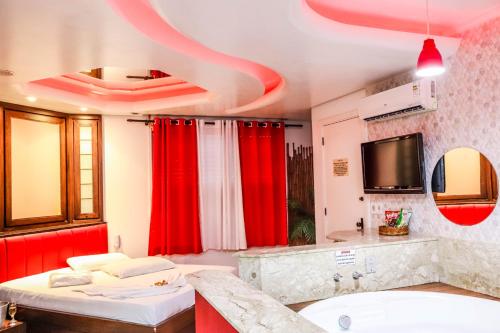 a bathroom with red curtains and a sink at Taikô Motel by Drops in Porto Alegre