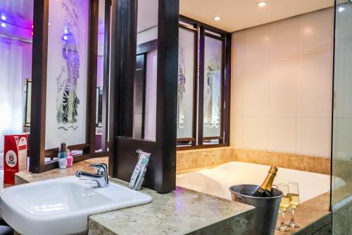 a bathroom with a sink and a tub at Taikô Motel by Drops in Porto Alegre