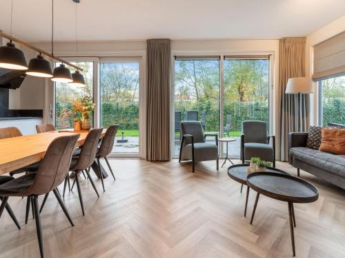 a living room with a table and a couch at Holiday Home in De Koog with Sauna and Garden in Westermient