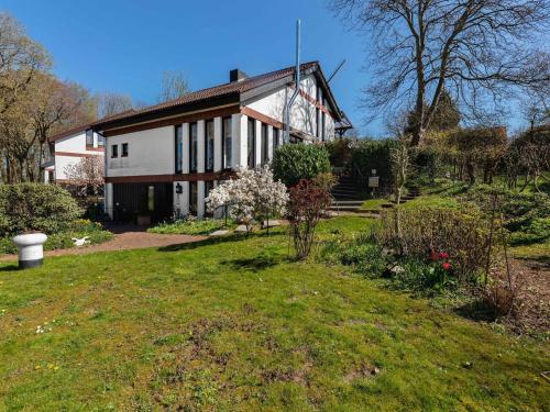 a large white house with a garden in front of it at Flat in Meldorf next to the town centre in Meldorf