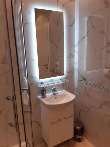 a bathroom with a sink and a mirror at Zajazd Pod Jesionami in Nisko