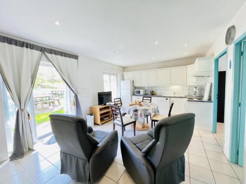 a kitchen and living room with a table and chairs at Residence Louis Le Lavoir in Bains-les-Bains
