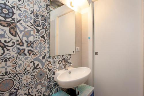 a bathroom with a sink and a mirror at Hora Mare in Orosei