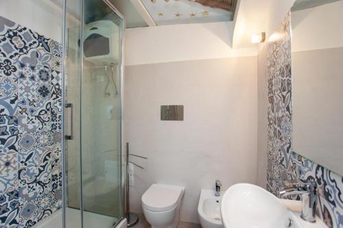 a bathroom with a shower and a toilet and a sink at Hora Mare in Orosei