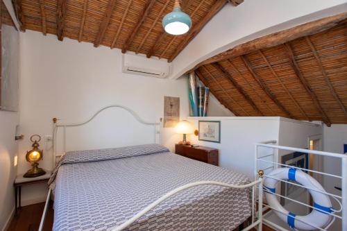 a bedroom with a bed and a wooden ceiling at Hora Mare in Orosei