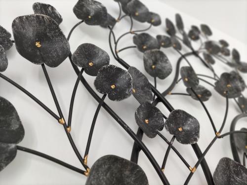 a group of black plastic flowers on a white surface at PIEDRA DE LUNA in Merida