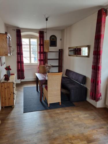 a living room with a table and a couch at Vila Lucia - Apartmán 3 in Plzeň