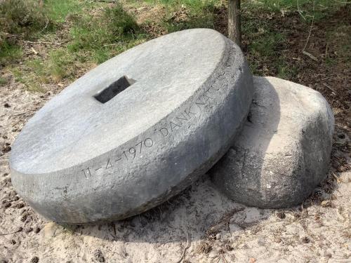 a stone monument sitting on the ground in the dirt at 't Greefsch Geluck in Kalmthout