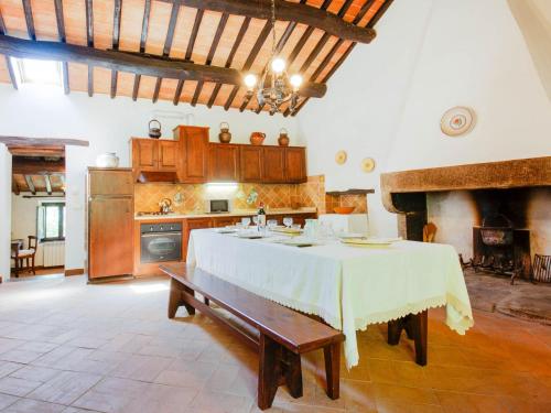 a large kitchen with a table in a room at Belvilla by OYO Eremo di Fieri in Cortona
