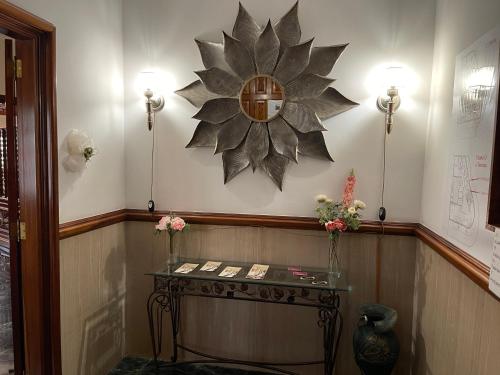 a room with a table and a clock on the wall at Il Sogno di Gio de la Laguna in La Laguna