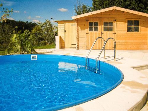 a swimming pool in front of a house at Sunny house with private pool in Nadaillac-de-Rouge