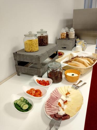 a table with plates of food on a counter at Hotel Opera in Jaroměřice na Rokytné