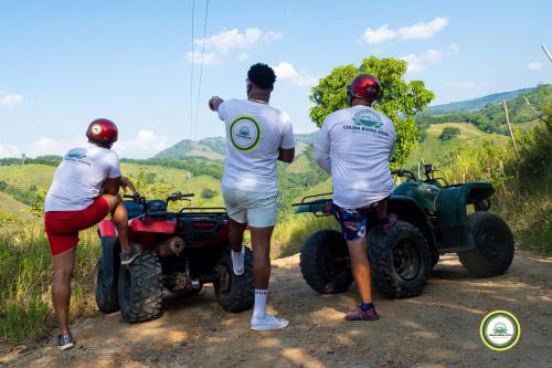 a group of three men standing around a wheeler at Colina Buena vista A4 in Jarabacoa