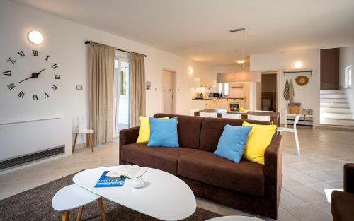 a living room with a couch and a table at Hvaretta Villas in Stari Grad