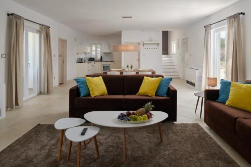 a living room with a couch and a table at Hvaretta Villas in Stari Grad
