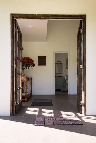 an open door into a room with a hallway at Casa Galpón en la Laguna de Aculeo in Paine
