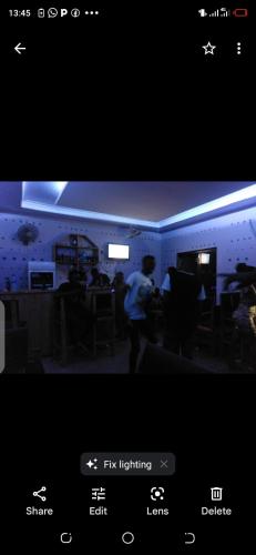 a picture of a person dancing in a room at Kicec bar and guest house airport in Dar es Salaam
