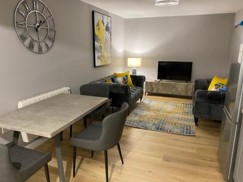 a living room with a table and a couch at Dunlap Apartments in Strabane