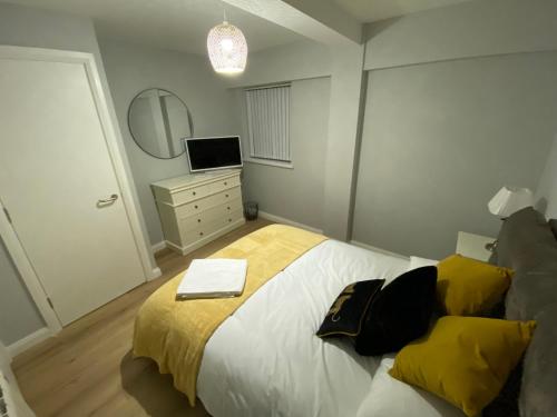 a bedroom with a large bed and a mirror at Dunlap Apartments in Strabane