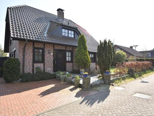a house with a brick driveway in front of it at Spacious Mansion with Meadow View in Bruinisse in Bruinisse