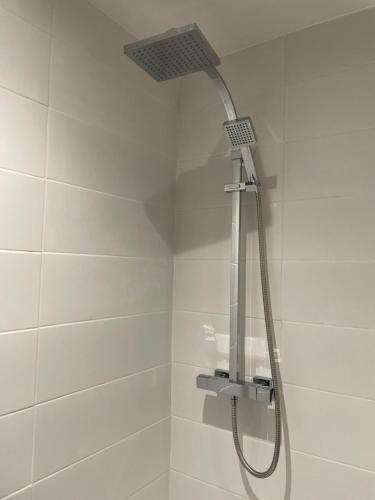 a shower stall with a shower head on the wall at Woodlands Hall Hotel in Ederyn