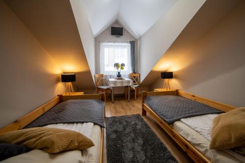 En eller flere senge i et værelse på Gościniec pod Lilijką