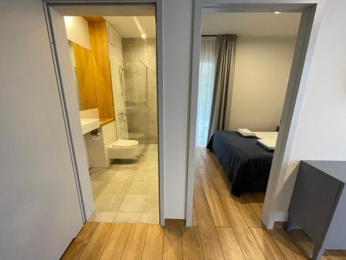 a small bathroom with a bed and a toilet at Apartament Szafir Mechelinki in Mechelinki