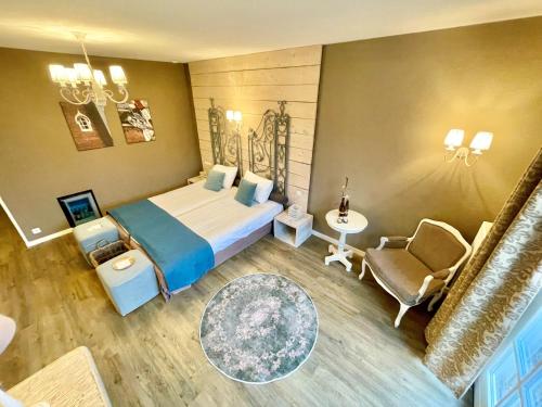 a hotel room with a bed and a chair at Hotel & Restaurant - Auberge De Hilver in Diessen
