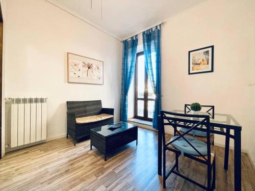 a living room with a table and a couch at B&B La Rocca in Caprarola
