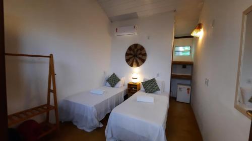 Cama ou camas em um quarto em Hospedaria Caraíva