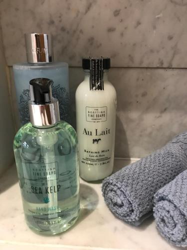 two bottles of soap sitting on a bathroom counter at The TollHouse in Stirling