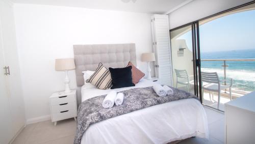 a bedroom with a bed with two towels on it at 1002 Bermudas - by Stay in Umhlanga in Durban