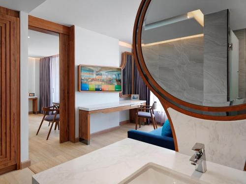 a bathroom with a sink and a mirror at The Oceanic Sportel Phuket - SHA Extra Plus in Phuket Town